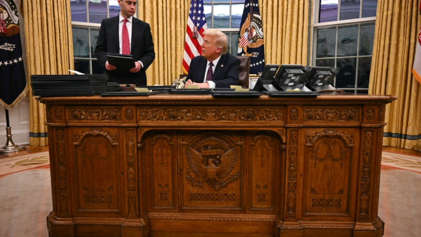 নির্বাহী আদেশে সাক্ষর করছেন ট্রাম্প। ছবি: এএফপি