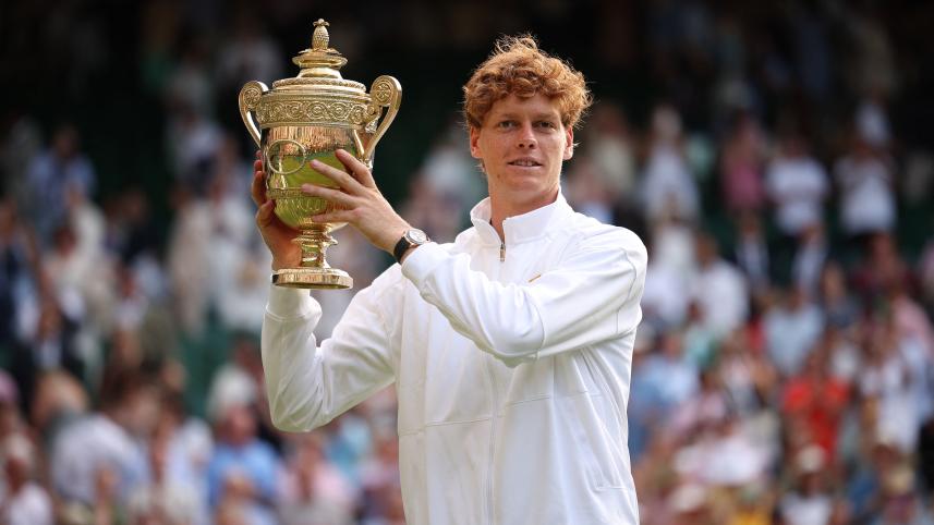 Italy's Jannik Sinner celebrates with the winner's trophy