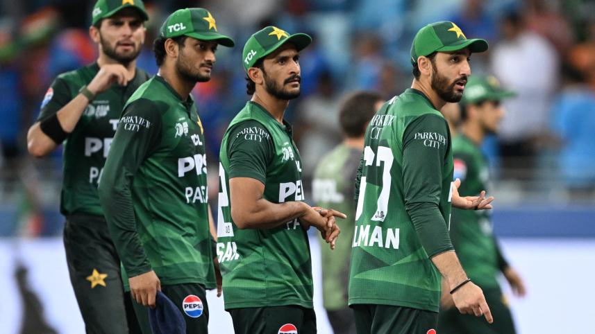 Pakistan's players walk back to the pavilion at the end of the Asia Cup 2025 Twenty20 international cricket match against India at the Dubai International Stadium