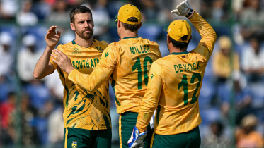 South Africa's Anrich Nortje (L) celebrates with teammates