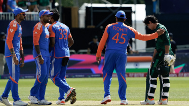 India's captain Rohit Sharma (2nd R) gives a pat on the shoulder to Pakistan's Naseem Shah (R) 
