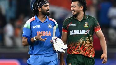 India's KL Rahul (L) speaks with Bangladesh's Taskin Ahmed