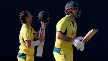 Australia’s Travis Head (L) reacts as he celebrates after reaching his century with team mate and captain Mitchell Marsh 