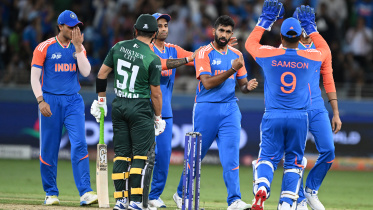 India's players celebrate after taking the wicket of Pakistan's Mohammad Haris 