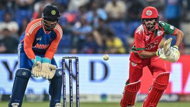 Oman's Hammad Mirza (R) plays a shot during the Asia Cup 2025 Twenty20 international cricket match between India and Oman at the Sheikh Zayed Cricket Stadium in Abu Dhabi 
